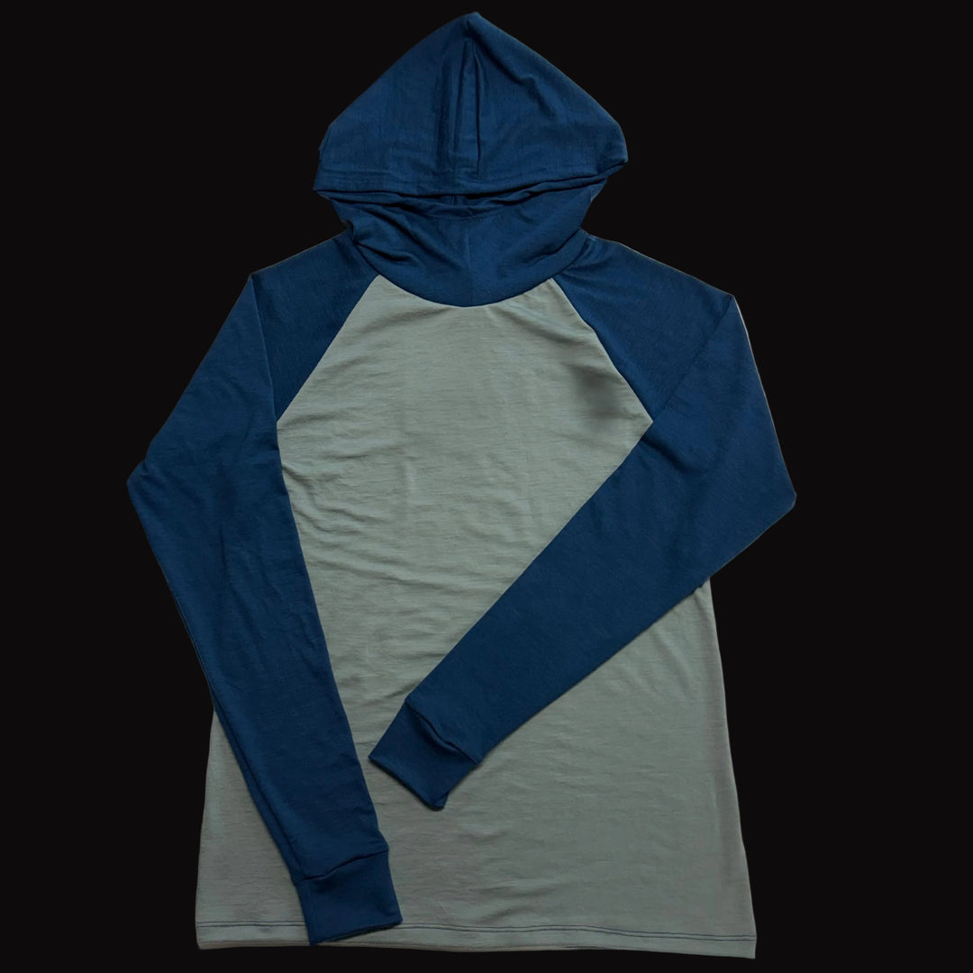 A long-sleeve raglan hoodiefeaturing a blue hood and sleeves with a muted sage green body.