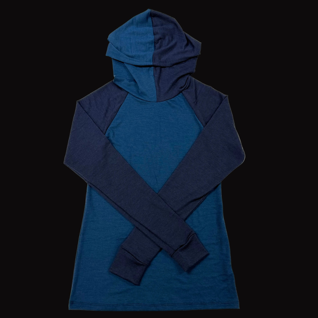 A long-sleeve merino wool hooded shirt with a color-blocked design in dark blue and navy