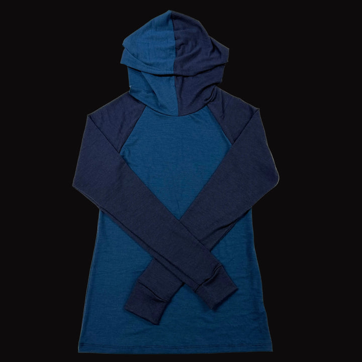 A long-sleeve merino wool hooded shirt with a color-blocked design in dark blue and navy