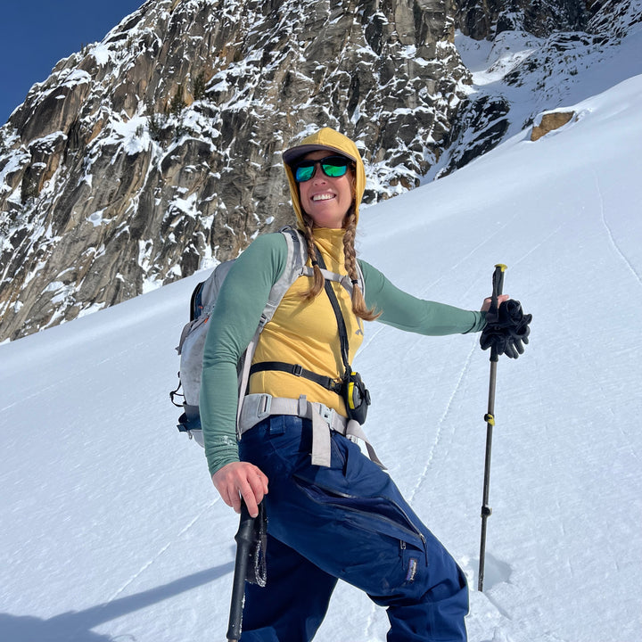 ski touring in a merino wool baselayer hoodie in the north cascades