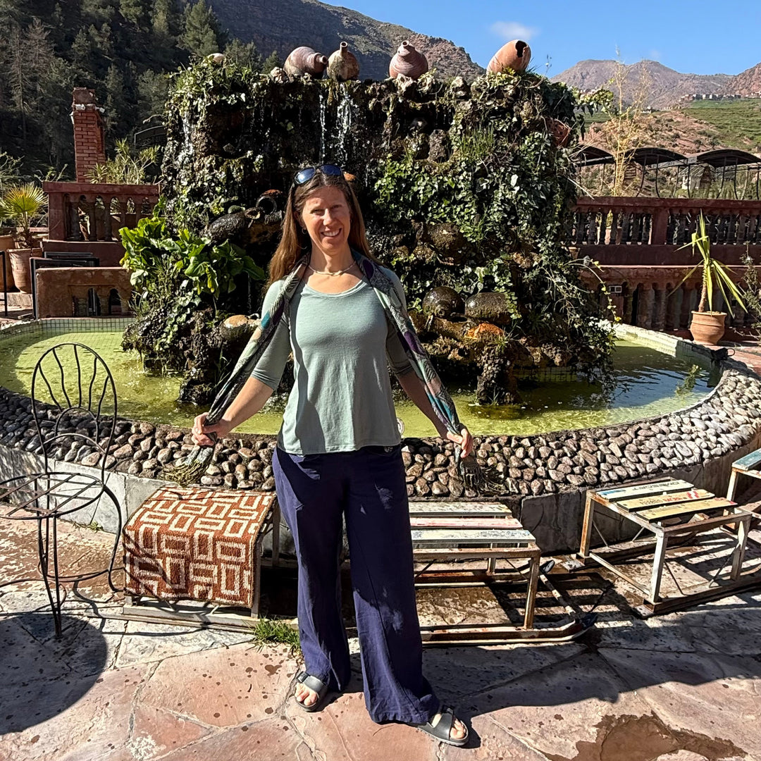 Betsy Cassell-Thomas owner of Intertwined Designs wearing a merino wool shirt in Morocco while traveling